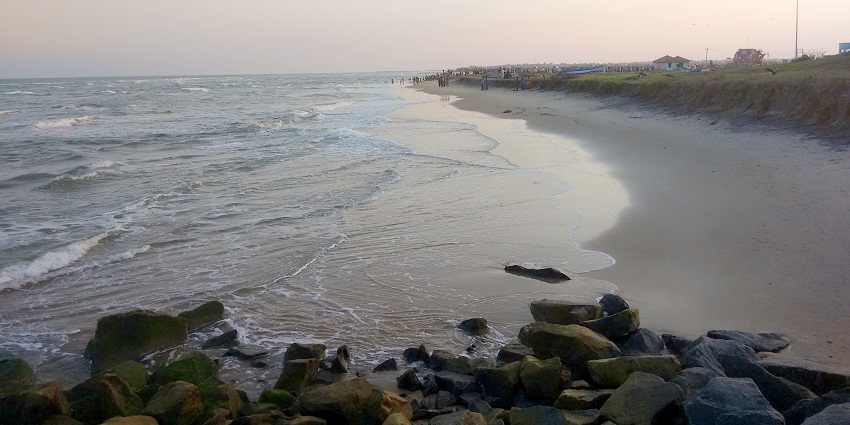 Silver Beach with a sandy shore, gentle waves, and people enjoying the coastline.