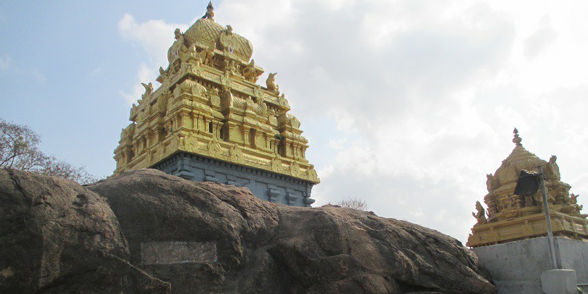 Singaperumal Temple with ornately carved gopuram adorned with detailed sculptures.