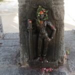 One of the many statues of god installed on a pillar, inside the Shivanmalai Temple.