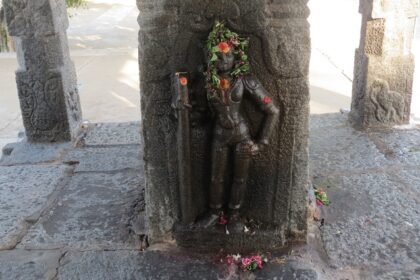 One of the many statues of god installed on a pillar, inside the Shivanmalai Temple.