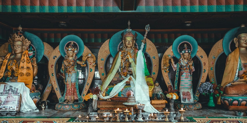 A beautifully adorned altar featuring Hindu deities decorated with flowers.