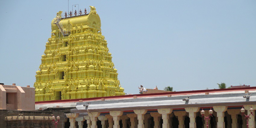 A distant view of an astonishing temple that has a gold colour on its outer surface