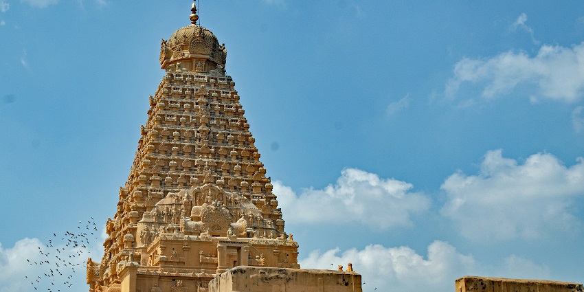 Pagodas during daytime with ornate details and a clear blue sky in the background.