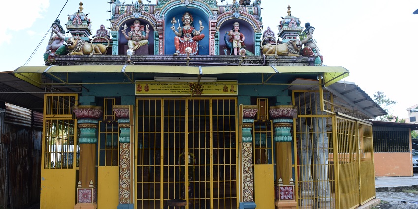 An image of the outside of the Naduthurai Sri Devi Karumariamman temple facade.