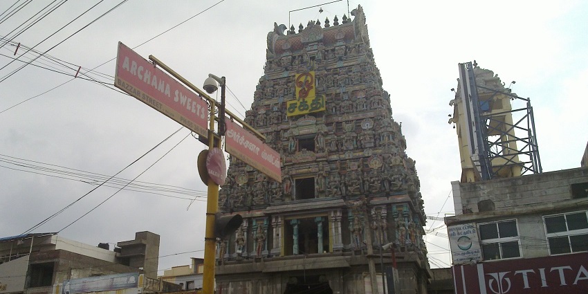 Kottai Mariamman Temple entrance with its vibrant gopuram surrounded by buildings