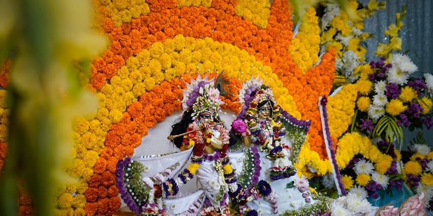 Hindu altar featuring colorful decorations and figurines, creating a vibrant worship space