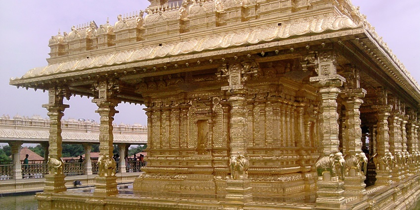 Gold-covered Sri Lakshmi Narayani Golden Temple with a lake surrounding the temple.