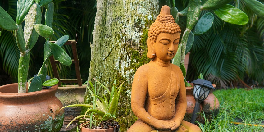 A statue of Lord Buddha under a Bodhi tree, among the holy Buddha temples in Chennai.
