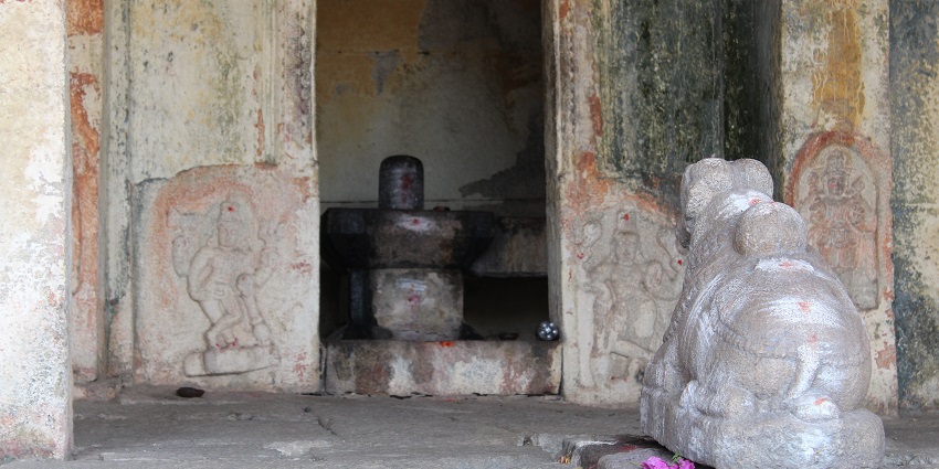 Lord Shivaling seated inside the shrine with Nandi carved into a stone sitting outside.