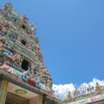 Ornate facade of Sri Prathyangira Devi Temple with colourful statues and intricate carvings