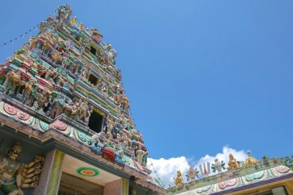 Ornate facade of Sri Prathyangira Devi Temple with colourful statues and intricate carvings