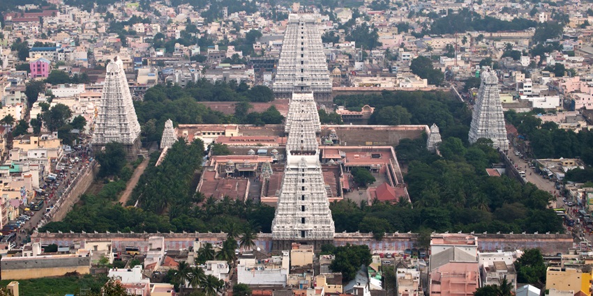 A temple complex featuring towering gopurams and intricate carvings in Dravidian style
