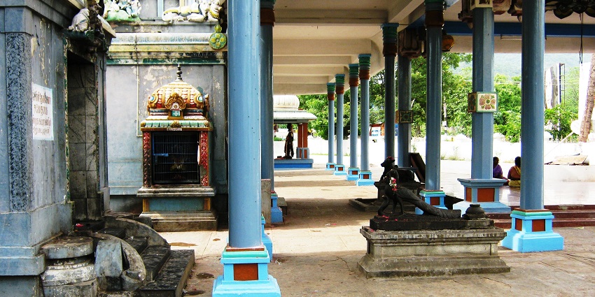 Outside gallery of Sri Panchamukha Vinayagar temple with people sitting near the pillars