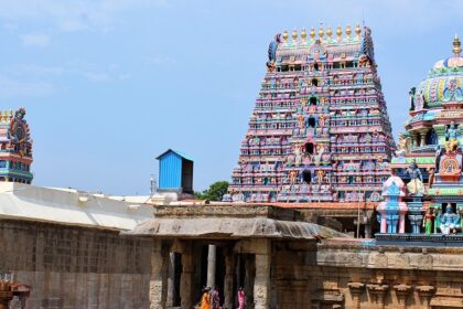 Srimushnam Temple structure towering gopuram with detailed sculptures under a clear sky.