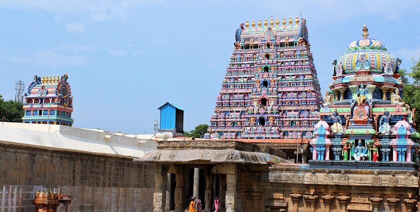 Srimushnam Temple structure towering gopuram with detailed sculptures under a clear sky.