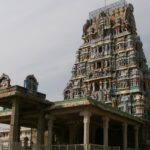 Sriperumbudur Temple with colourful gopuram, vehicles parked, and people in the foreground