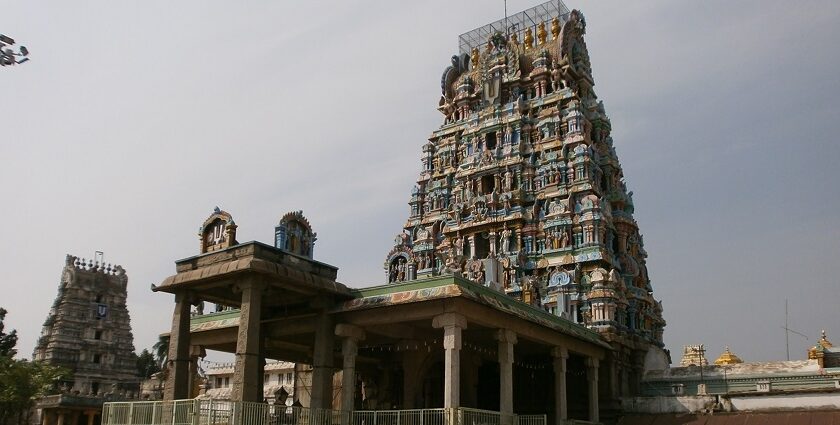 Sriperumbudur Temple with colourful gopuram, vehicles parked, and people in the foreground