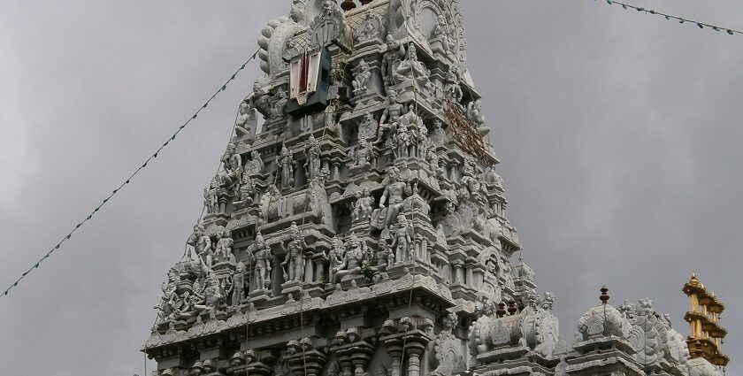 A distant view of a Srivanjiyam temple, surrounded by lush greenery