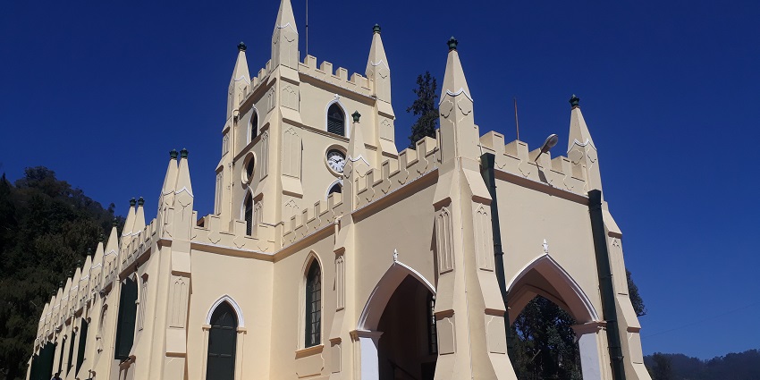 A stunning front view of a charming church, with its towering spires, classic stone architecture.