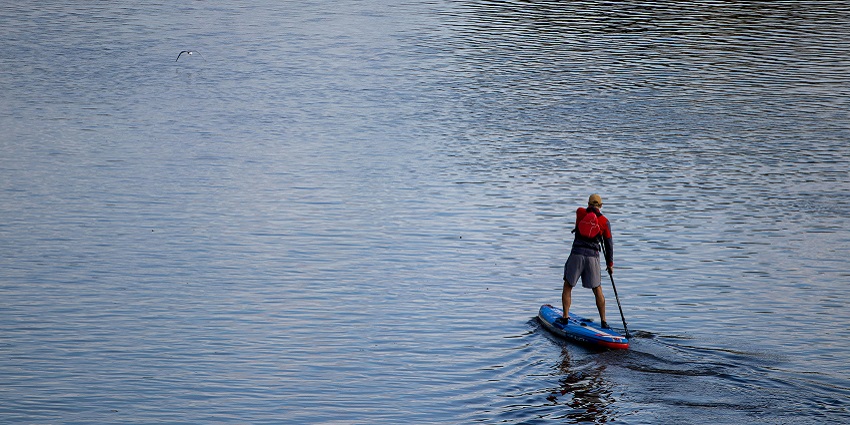 A glimpse of Stand-Up Paddleboarding, a fun water activity balancing on board.