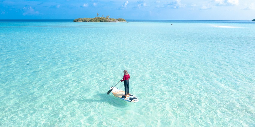 An image capturing paddleboarders, which is one of the best water sports in Kihim.