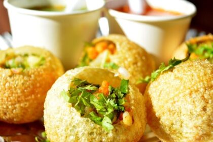 Delicious Pani Puris are filled with filling and served along the flavoured water