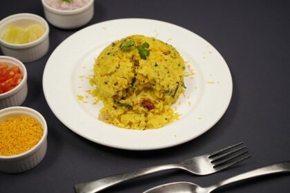 Authentic Maharashtrian dish Poha is served on a platter topped with mint leaves