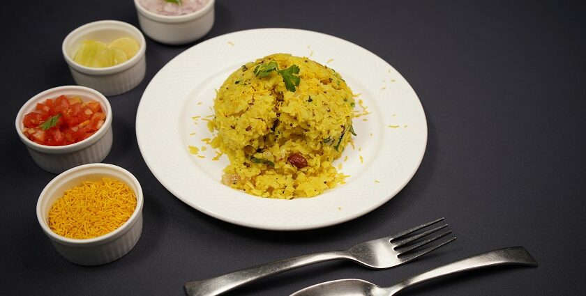 Authentic Maharashtrian dish Poha is served on a platter topped with mint leaves