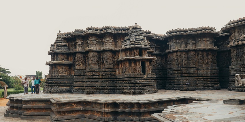 A picture of a temple complex with traditional architecture and green surroundings