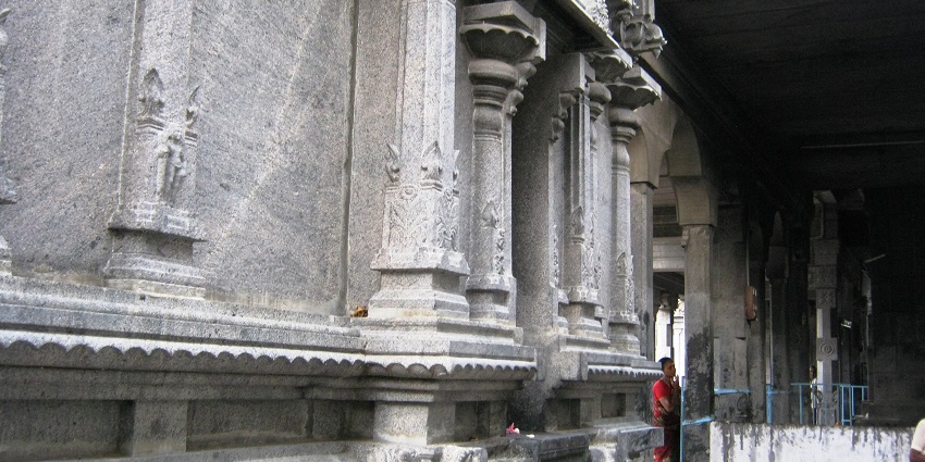 An inside view of the Sugavaneshwarar temple showcasing its stone-carved walls
