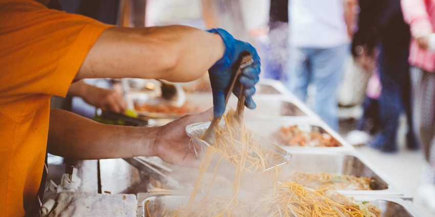 Image of a Person in Orange Shirt Holding Aluminum Rectangular Container - packing delectable food