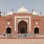 Image of picturesque Taj Mahal Mosque premises during the daytime under blue sky