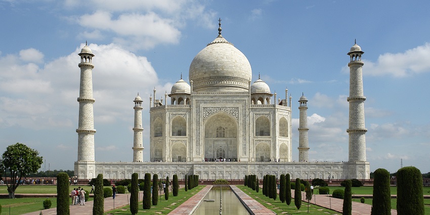 Taj Mahal, an iconic white marble mausoleum reflecting Mughal architectural grandeur