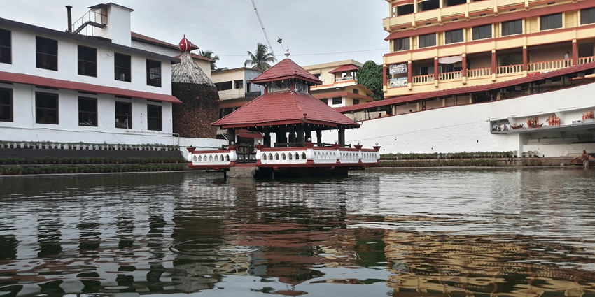 A scenic view of a tranquil temple tank, a holy attraction near Thiruvenkadu Temple.