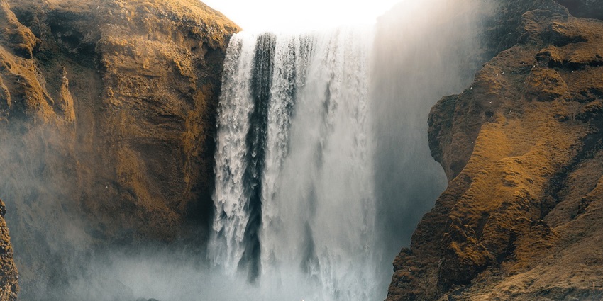 A view of an epic waterfall near Vindhyachal temple, surrounded by vegetation.