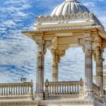 Magnificent Hindu temple with intricate carvings and tall spires, set against a clear blue sky