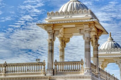 Magnificent Hindu temple with intricate carvings and tall spires, set against a clear blue sky