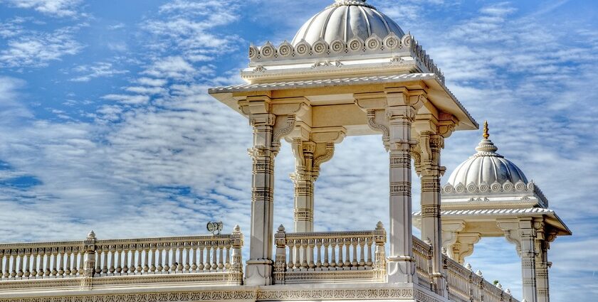 Magnificent Hindu temple with intricate carvings and tall spires, set against a clear blue sky