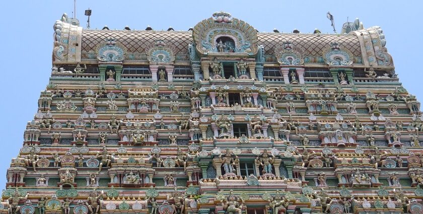 Kaasi Viswanathar Tenkasi Temple is filled with sculptures of idols against the vividly colourful wall.