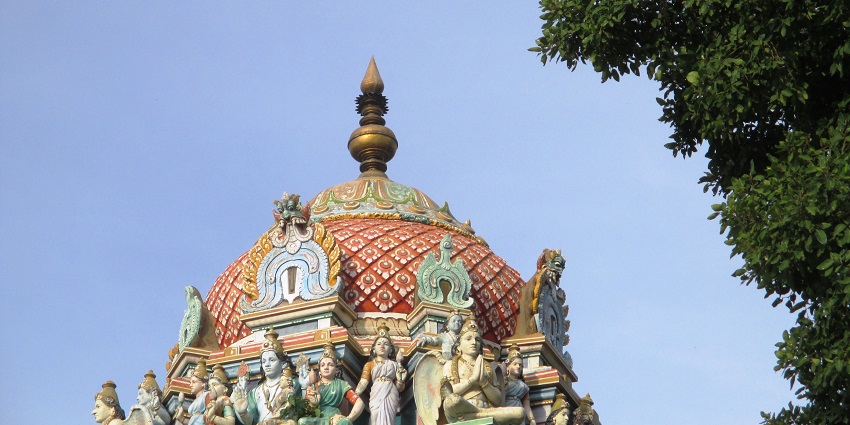 An outside view of a temple showcasing the carved sculptures on its outer surface.