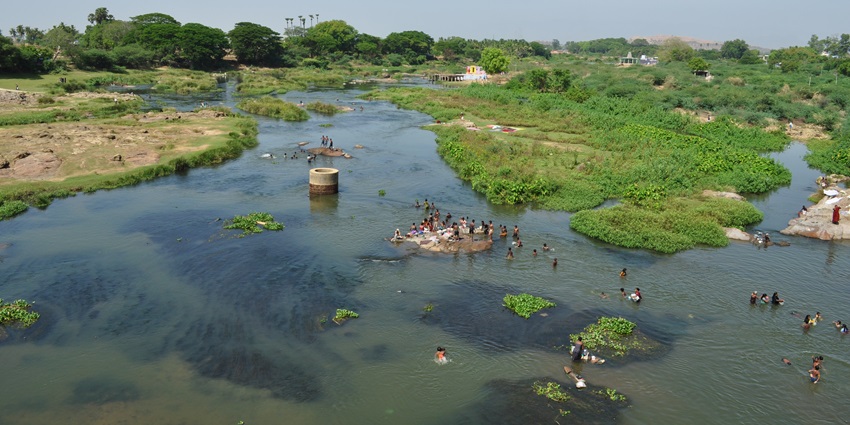 An aerial view of Thamirabarani River surrounded by lush green vegetation in Tamil Nadu.