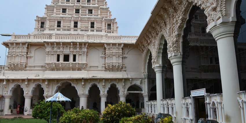Thanjavur Royal Palace Museum with grand arches, detailed pillars, and green courtyards.