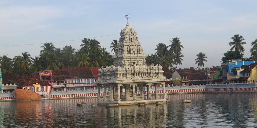 A glorious temple adorned with unique architecture & surrounding calm, reflective waters