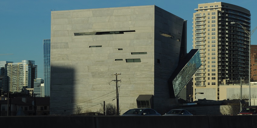 The Perot Museum of Nature and Science with cubic architecture and cars parked near it