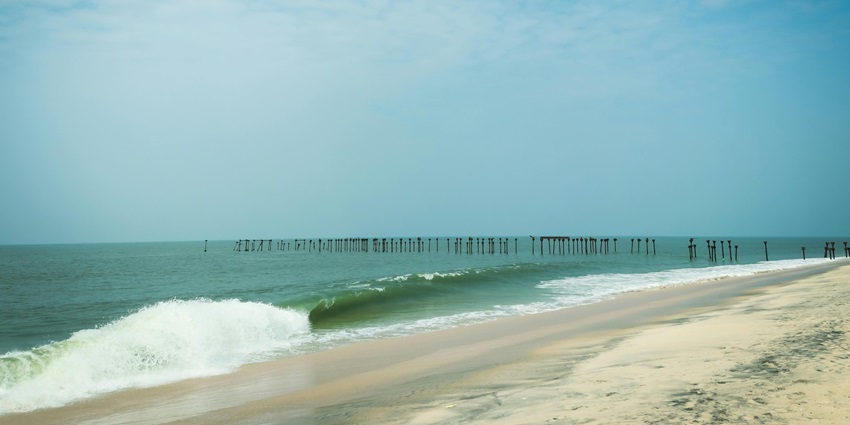 A famous beach in Nagercoil with gentle waves lapping at the shore, creating a calm coastal scene.