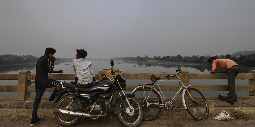 Tourists enjoying the view from the lake near Barua Sagar Fort.