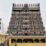 A picture of a decorated temple tower exhibiting a lot of work in a close-up shot.