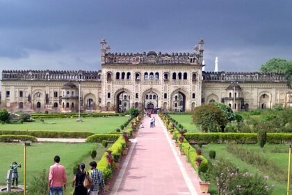 An image of Imamabara in daylight with busy roads and beautiful architecture in Lucknow, India.