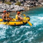 A glimpse of people enjoying rafting on the shimmering blue waters of Uttarakhand.