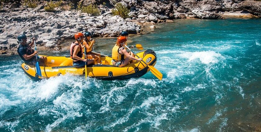 A glimpse of people enjoying rafting on the shimmering blue waters of Uttarakhand.